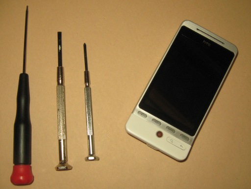 A T5 Torx, a flat head, a 0x50 Phillips and an HTC Hero G3.