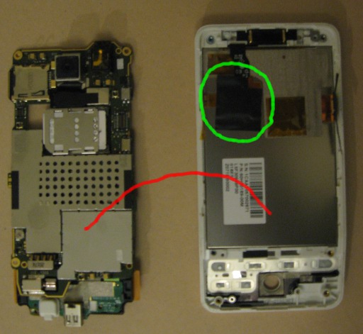 An adhesive pad is located in the upper left quarter of the phone and is black.